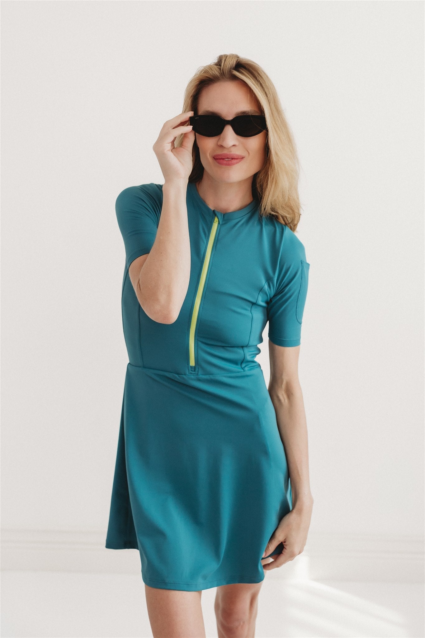 Woman standing and wearing blue UPF swim dress
